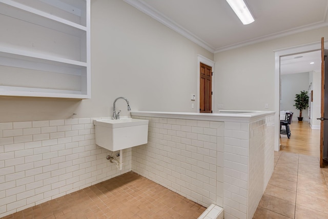 1020 Peninsula Xing, Evans, GA 30809 - kitchen featuring ornamental molding, a sink, light countertops, and light tile patterned flooring