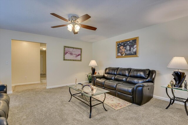 carpeted living room with ceiling fan