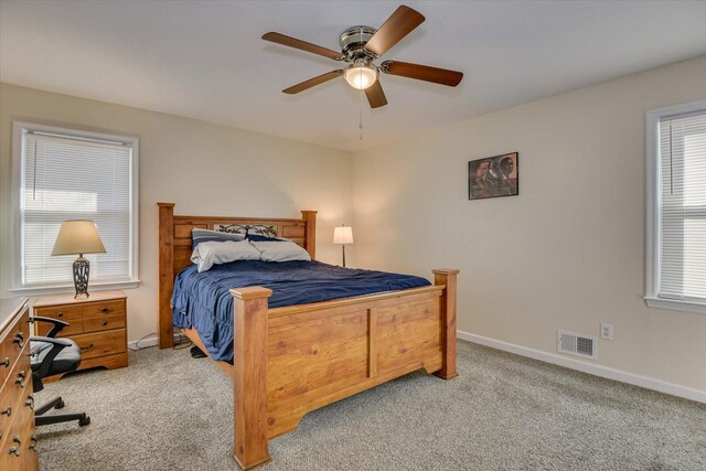 carpeted living room featuring ceiling fan