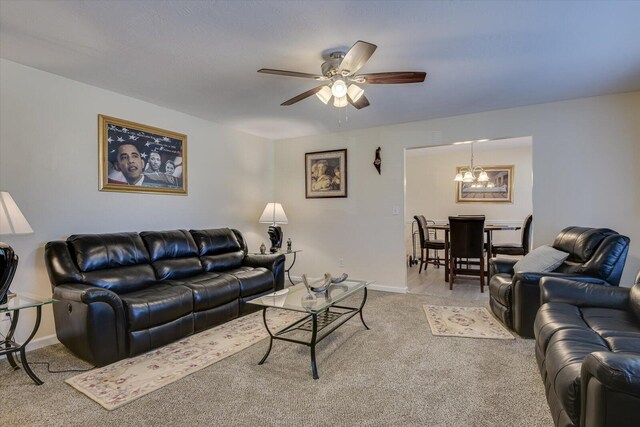 dining room featuring ceiling fan with notable chandelier and carpet floors