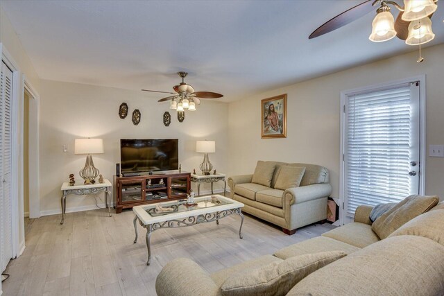 living room with ceiling fan, a healthy amount of sunlight, and light hardwood / wood-style flooring