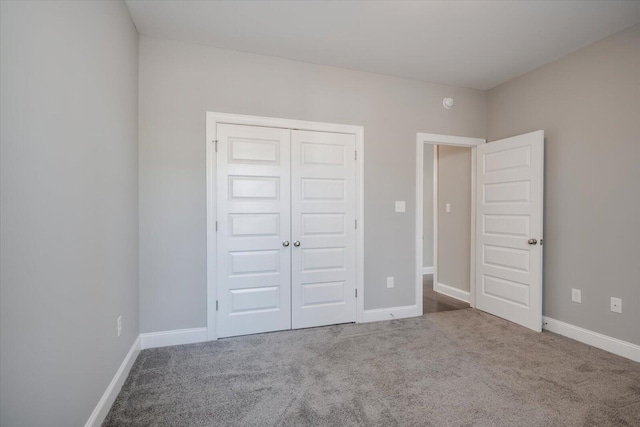 unfurnished bedroom featuring a closet and carpet floors