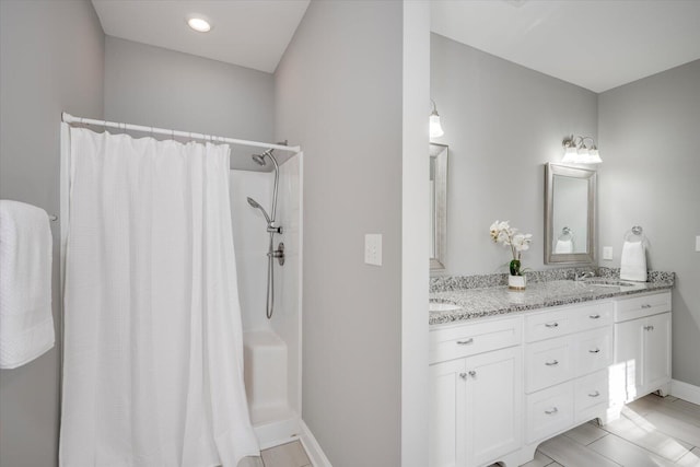 bathroom with curtained shower and vanity