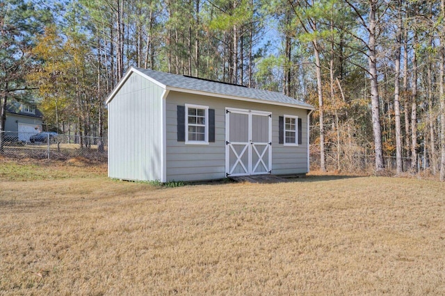 view of outbuilding featuring a yard