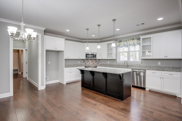 kitchen with a center island, white cabinetry, and stainless steel appliances