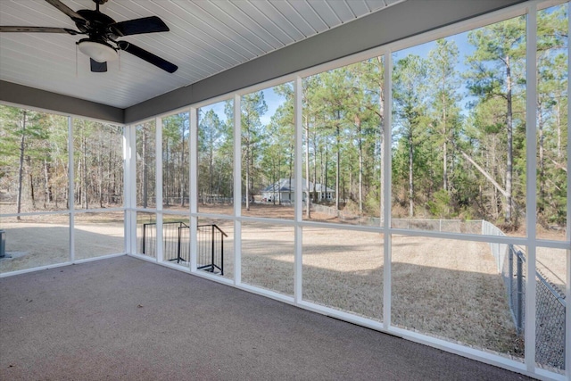 unfurnished sunroom with ceiling fan and a healthy amount of sunlight