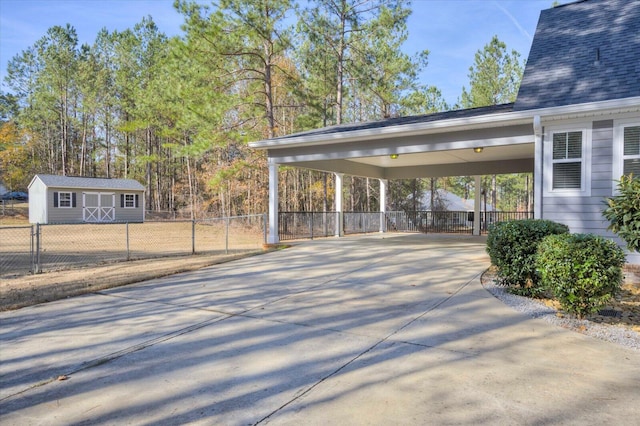 view of patio featuring a carport and an outbuilding