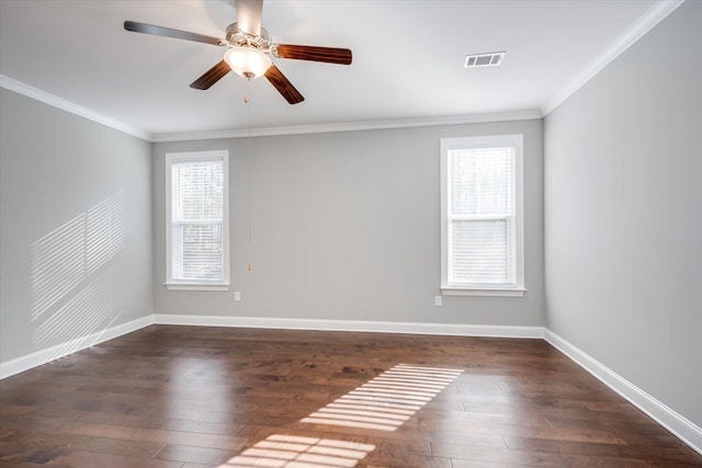 spare room featuring dark wood-type flooring, ceiling fan, and crown molding