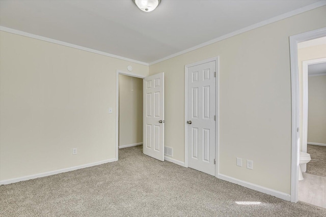 unfurnished bedroom with carpet, visible vents, crown molding, and baseboards