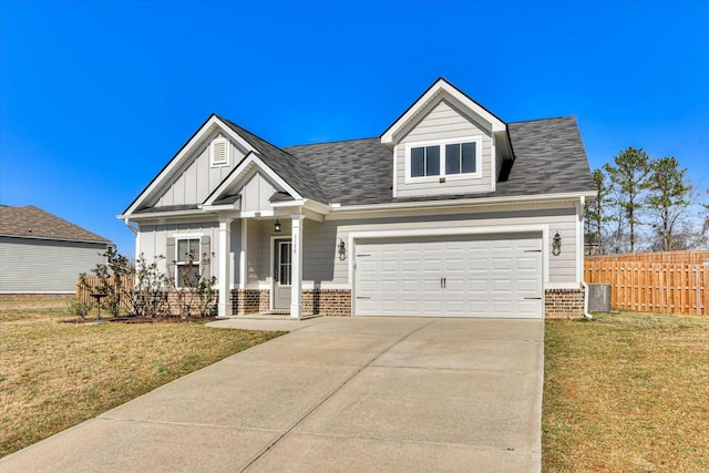 view of front of home featuring board and batten siding, a front yard, fence, and brick siding