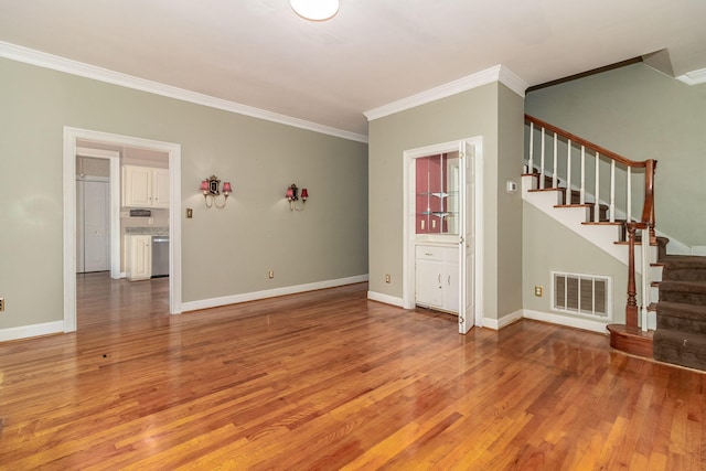 2531 Tupelo Dr, Augusta, GA 30909 - unfurnished living room with ornamental molding, stairway, and light wood-style floors