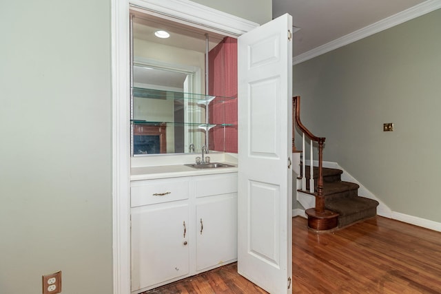 2531 Tupelo Dr, Augusta, GA 30909 - indoor wet bar with ornamental molding, stairway, and wood finished floors