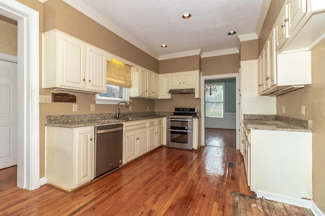 2531 Tupelo Dr, Augusta, GA 30909 - kitchen with stainless steel appliances, hardwood / wood-style flooring, crown molding, stone counters, and under cabinet range hood