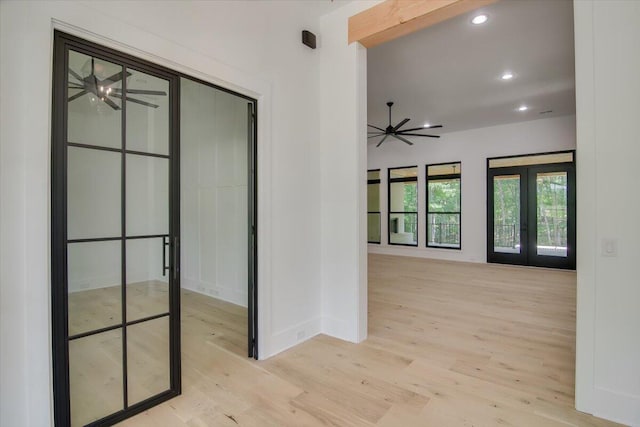 hallway with french doors and light wood-type flooring