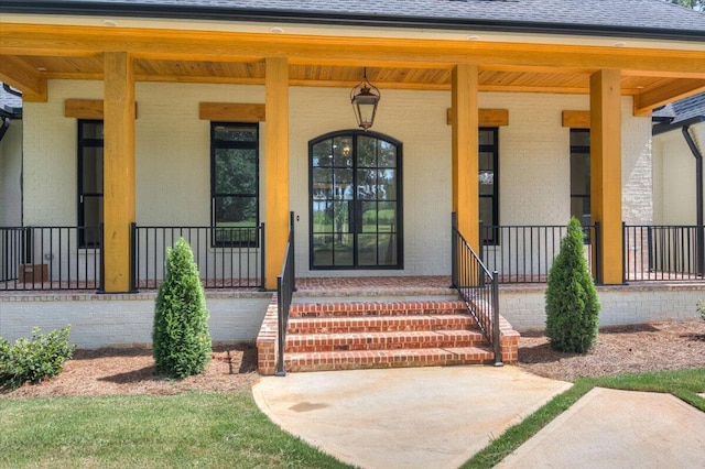 view of exterior entry featuring a porch