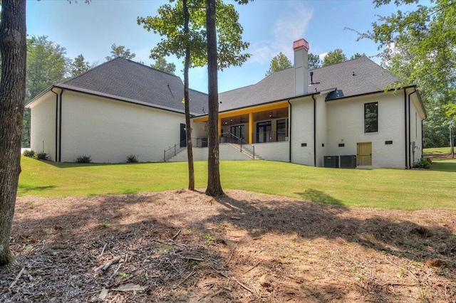 back of house featuring a yard and cooling unit