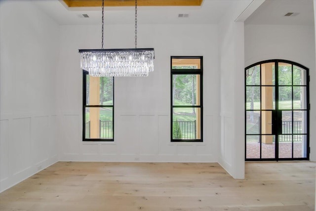 interior space with an inviting chandelier and light hardwood / wood-style flooring