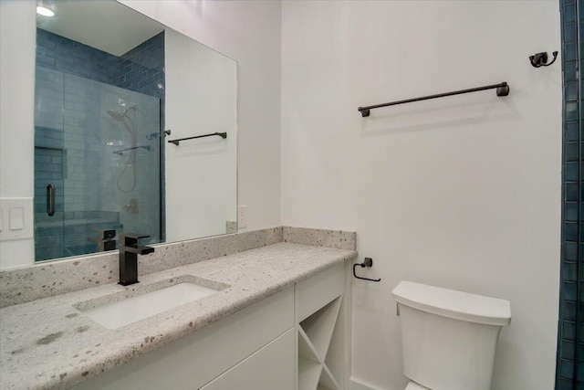 bathroom featuring vanity, toilet, and walk in shower