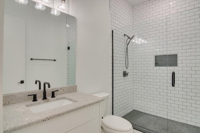 bathroom featuring walk in shower, vanity, and toilet