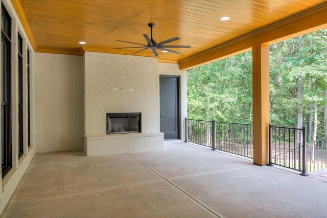 view of patio / terrace featuring ceiling fan and an outdoor brick fireplace