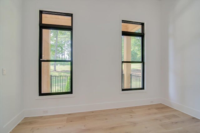 unfurnished room with light hardwood / wood-style flooring