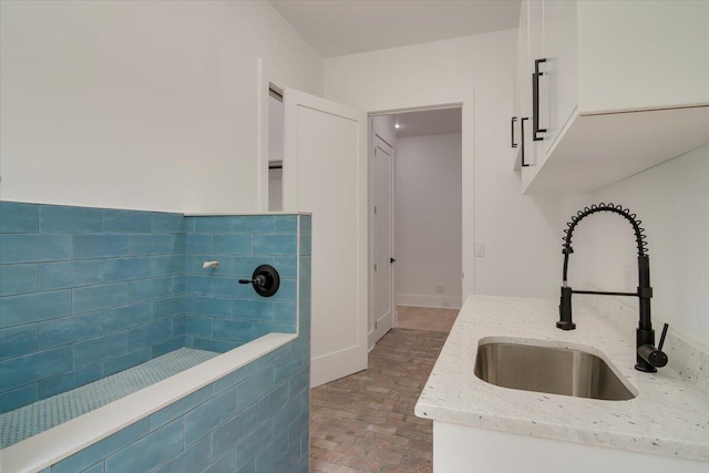 kitchen with light stone countertops and sink