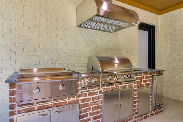 details featuring fridge and wall chimney range hood