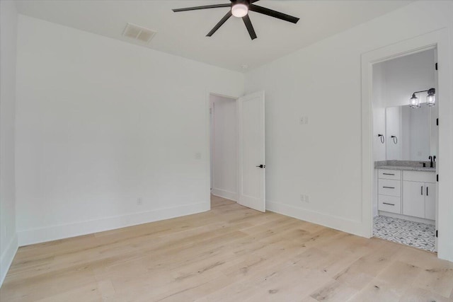 unfurnished bedroom with ceiling fan, light hardwood / wood-style floors, sink, and ensuite bath