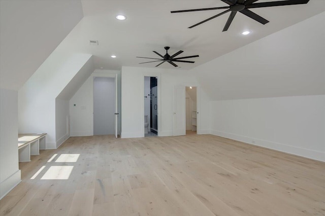 additional living space with light hardwood / wood-style floors, vaulted ceiling, and ceiling fan