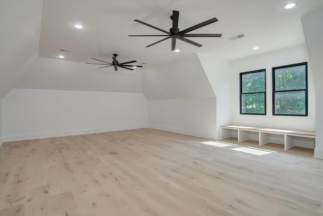 bonus room featuring ceiling fan, vaulted ceiling, and light wood-type flooring