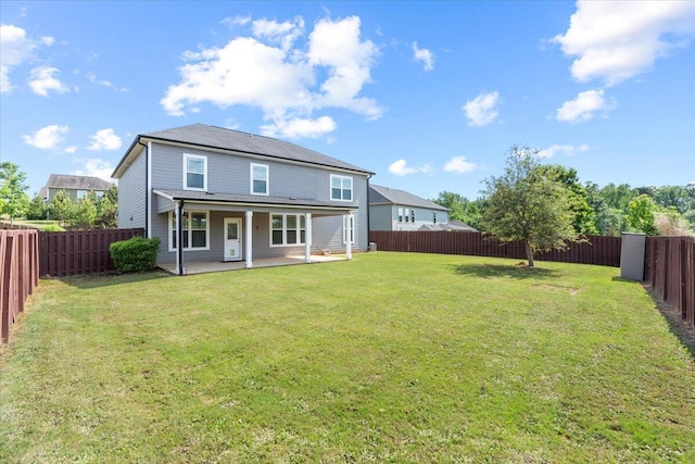 back of house featuring a yard and a patio