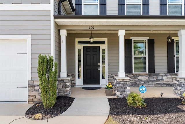 property entrance with a porch and a garage