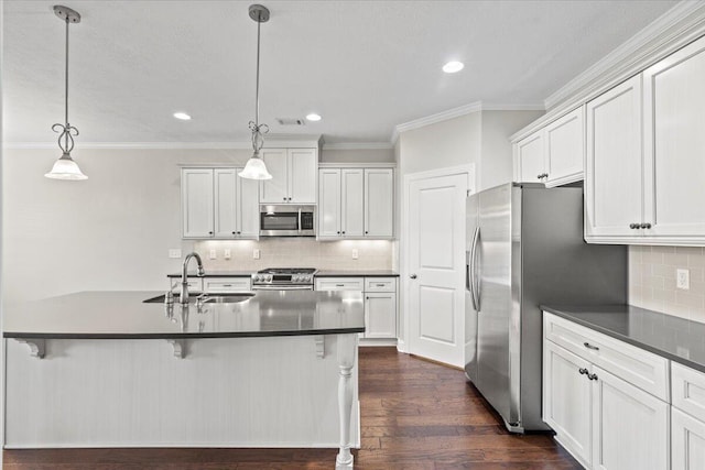 kitchen with decorative light fixtures, sink, white cabinetry, and stainless steel appliances