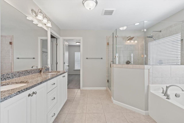 bathroom with tile patterned floors, vanity, and shower with separate bathtub