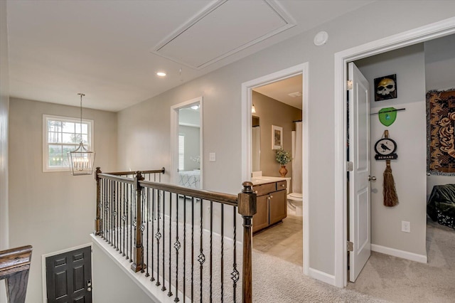 hall featuring baseboards, attic access, recessed lighting, light carpet, and an upstairs landing