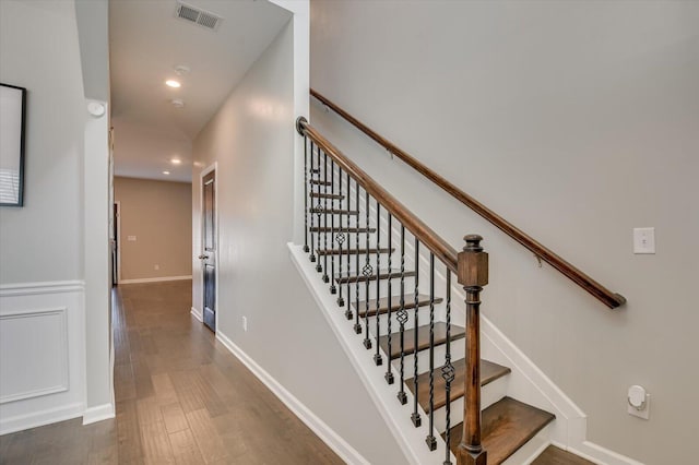 stairs featuring visible vents, recessed lighting, baseboards, and wood finished floors