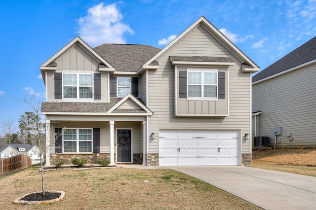 craftsman inspired home featuring concrete driveway, central air condition unit, board and batten siding, and stone siding