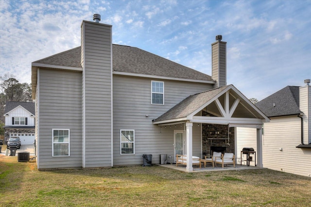 back of property featuring central air condition unit, roof with shingles, a chimney, a yard, and a patio area