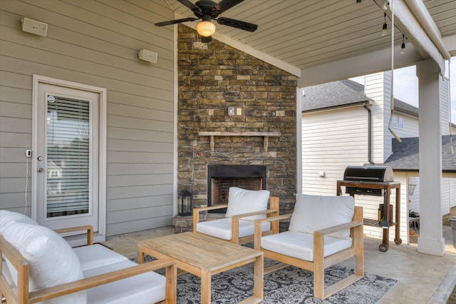 view of patio / terrace with an outdoor living space with a fireplace, a ceiling fan, and area for grilling