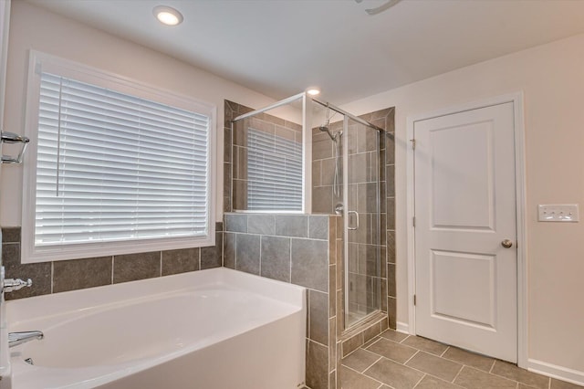 bathroom featuring tile patterned flooring, a shower stall, a bath, and recessed lighting