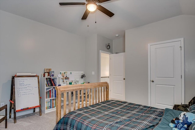 carpeted bedroom with ceiling fan and vaulted ceiling