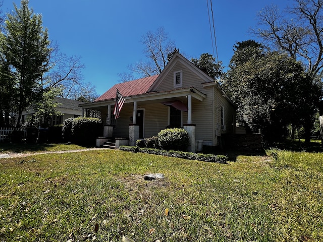 view of front of property with covered porch and a front lawn