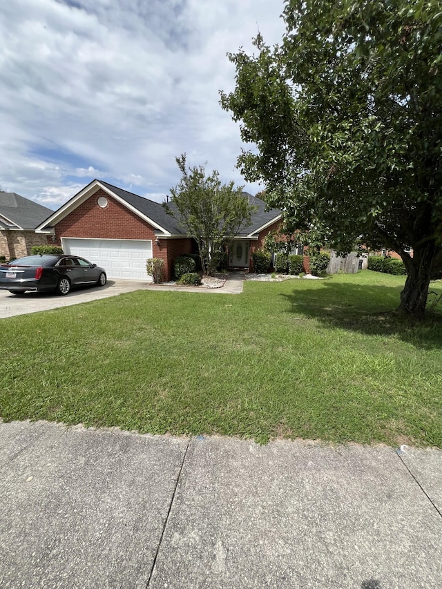 698 Cumberland Fls, Grovetown, GA 30813 - view of front of house with a front lawn, an attached garage, driveway, and brick siding