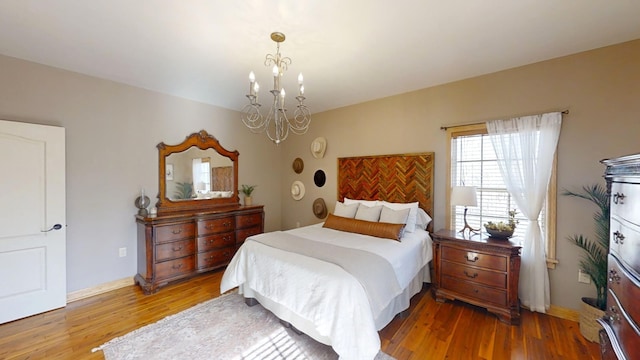 bedroom with an inviting chandelier and wood-type flooring