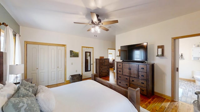 bedroom featuring ceiling fan, a closet, light hardwood / wood-style flooring, and ensuite bath