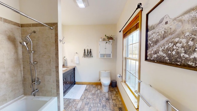 full bathroom featuring toilet, vanity, and tiled shower / bath combo