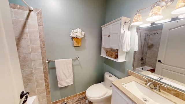 full bathroom with tiled shower / bath combo, vanity, and toilet