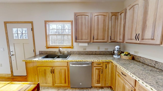 kitchen with dishwasher, light brown cabinets, and sink