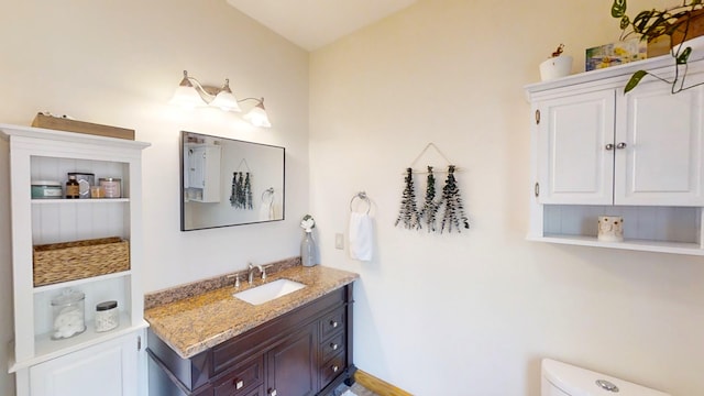 bathroom with toilet and vanity