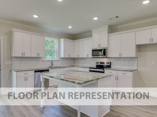 930 Walker Point Dr Unit Tp11, Grovetown, GA 30813 - kitchen with stainless steel appliances, a sink, white cabinetry, a center island, and ornamental molding